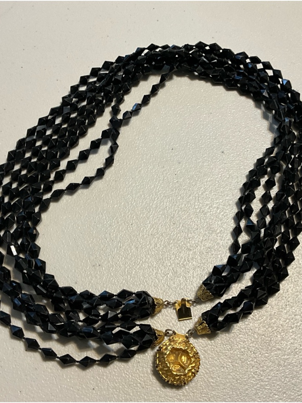 Black Multi-Strand Beaded Necklace with Gold Medallion